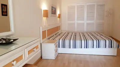 a small bedroom with a bed and a large window at Albufeira Ocean view (62) in Albufeira