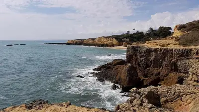 a beach with a rocky shoreline and the ocean at Albufeira Ocean view (62) in Albufeira