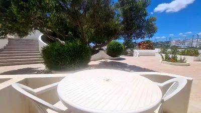 a white table and white chairs on a patio at Albufeira, Cerro Branco (41) in Albufeira
