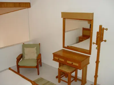 a dressing room with a chair and a mirror at Albufeira, Cerro Branco (42) in Albufeira