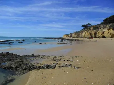 a sandy beach with rocks and the ocean at Albufeira, Ocean terrace (22) in Albufeira