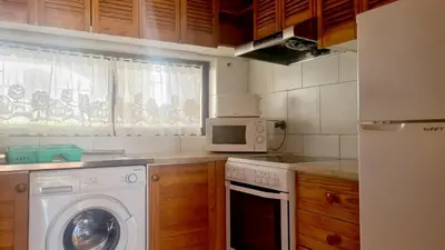 a kitchen with a washing machine and a microwave at Albufeira, Sea and old town view (32) in Albufeira
