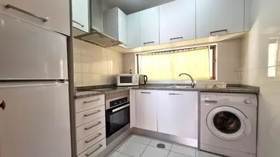 a kitchen with a washing machine and a microwave at Albufeira, Sea Balcony (11) in Albufeira