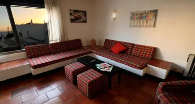 a living room with two couches and a table at Apartamentos Azul Mar in Albufeira