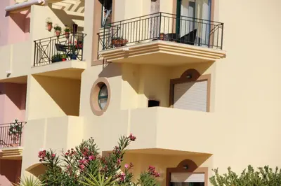 a parking lot in front of a large building at Appartement Villamoura in Vilamoura