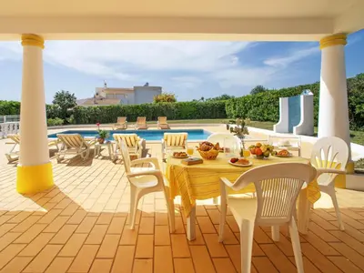 a patio with a table and chairs and a pool at Holiday Home Da Bela Vista by Interhome in Paderne