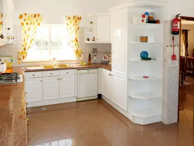 a kitchen with white cabinets and a window at Holiday Home Da Bela Vista by Interhome in Paderne
