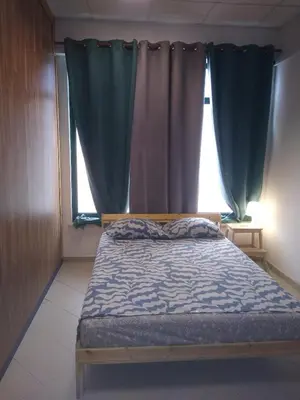 a bedroom with a bed in front of a window at Melaya Budget Hostel in Faro