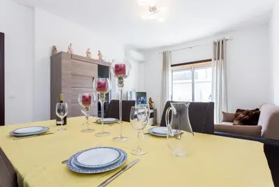a dining room table with wine glasses on it at Ouranascente in Albufeira