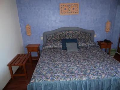 a bedroom with a bed with a blue wall at VilaBranca in Albufeira