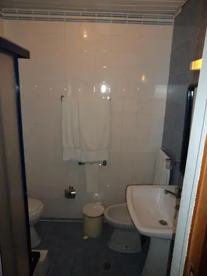a bathroom with a toilet and a sink at VilaBranca in Albufeira