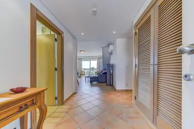 a hallway of a house with a door and a room at Apartamento Vila Sol com terraço e jacuzzi privad in Quarteira