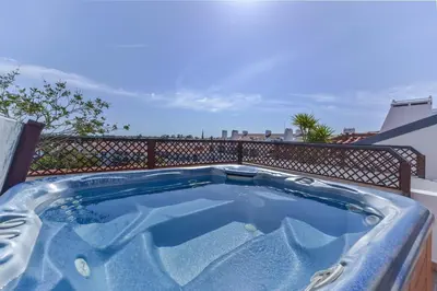 a hot tub on top of a balcony at Apartamento Vila Sol com terraço e jacuzzi privad in Quarteira