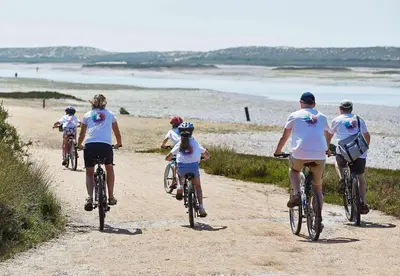 a group of people riding bikes on a beach at THE LAKERS Boutique Apartment in Quinta do Lago