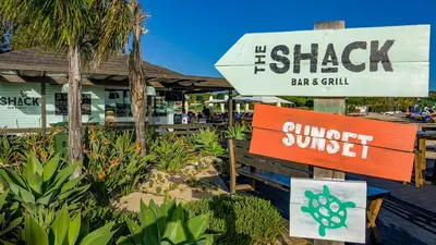 a sign in front of a bar and grill at THE LAKERS Boutique Apartment in Quinta do Lago