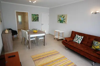 a living room with a couch and a table at Apartamento Velamar - 250 m from the Beach by Bedzy in Albufeira