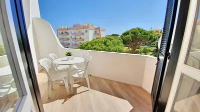 a small white table and chairs on a balcony at Apartamento 24 SOL in Vilamoura