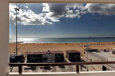 a view of a beach from a balcony at Edificio Albufeira Apartamentos A. Local - Albuturismo Lda in Albufeira