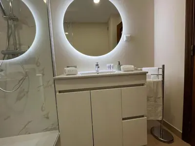 a bathroom with a sink and a mirror at Citymar by FHR T2 com piscina in Vilamoura