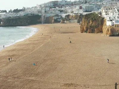 a group of people on a beach near the ocean at Bellavista Studio in Albufeira