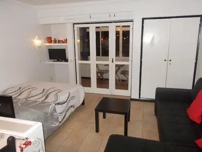 a living room with a bed and a couch at Bellavista Studio in Albufeira