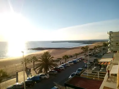 a parking lot with cars parked on the beach at Mamamia AC&Vista Magnifica in Quarteira