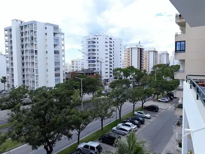 a city street with cars parked in a parking lot at SATÉLITE AC&Garagem in Quarteira