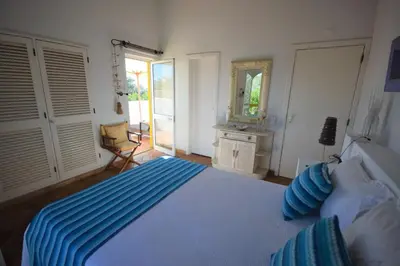 a bedroom with a bed with blue sheets and a mirror at V2 Aldeia Do Golf- Piscina, Familiar, Aconchegante in Vilamoura