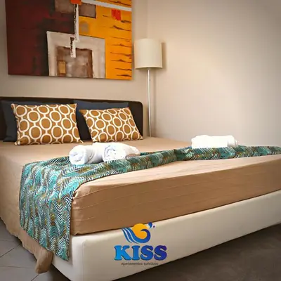a dining room with a table and a chair at Kiss - Apartamentos in Albufeira