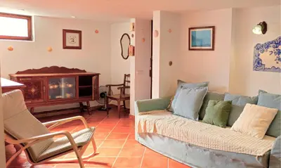 a living room with a couch and a fireplace at FLH Albufeira Açoteias Apartment in Albufeira