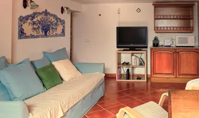 a living room with a blue couch and a tv at FLH Albufeira Açoteias Apartment in Albufeira