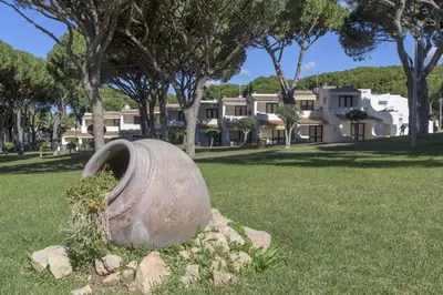 a statue in the grass with a building in the background at FLH Albufeira Açoteias Apartment in Albufeira