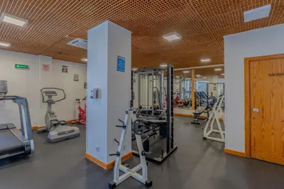 a gym with several treadmills and machines at Muthu Oura Praia Hotel in Albufeira