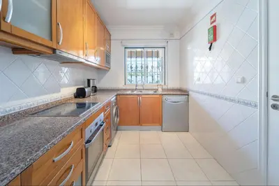 a kitchen with a sink and a dishwasher at Villa Balaia by HelloVacations in Albufeira