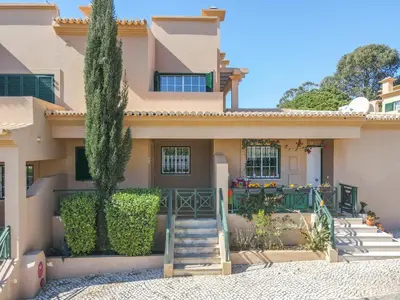 a house with a staircase in front of it at Villa Balaia by HelloVacations in Albufeira
