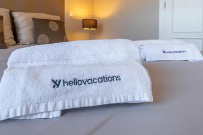 two towels on a bed in a bedroom at Villa Balaia by HelloVacations in Albufeira