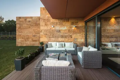 a patio with couches and a table on a deck at L Orangerie CA by Intiholidays in Vilamoura