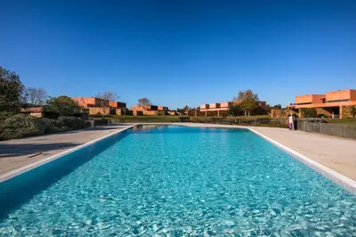 a large swimming pool with blue water at L Orangerie CA by Intiholidays in Vilamoura