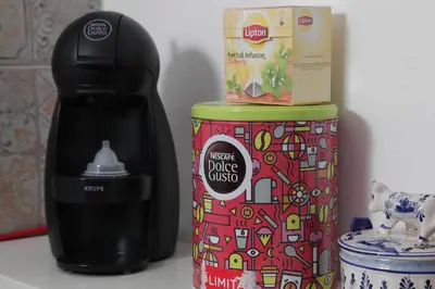 a coffee maker sitting next to a box of food at Casa das Andorinhas in Faro