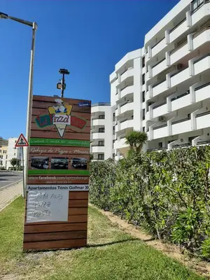 a sign in front of a tall building at Tenis Golfmar 409A - pool view in Vilamoura