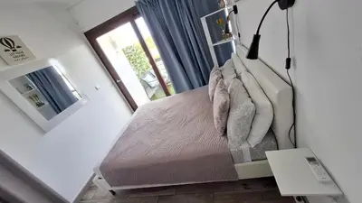 a small bed in a room with a window at Tenis Golfmar 409A - pool view in Vilamoura