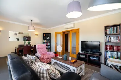 a living room with a couch and a tv at Loulé Charming in Loulé