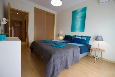 a bedroom with a large bed with blue pillows at Monte da Eira in Albufeira