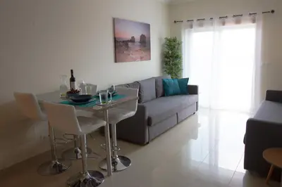 a living room with a table and a couch at Monte da Eira in Albufeira