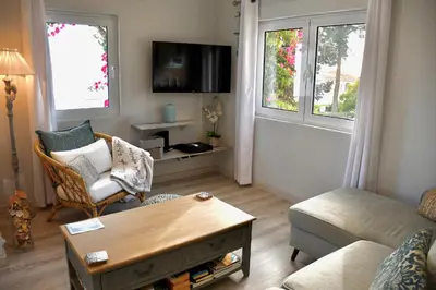 a living room with a couch and a coffee table at Aquamarine - Gemstone Getaway in Vale do Lobo