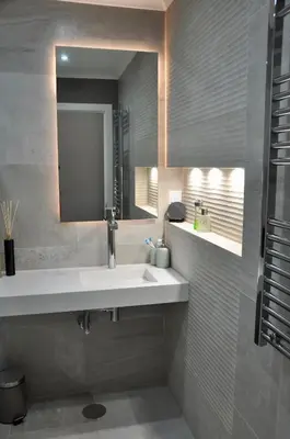 a bathroom with a white sink and a mirror at Aquamarine - Gemstone Getaway in Vale do Lobo