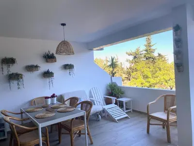a dining room with a table and chairs and a window at ExcelStay - Balaia in Albufeira