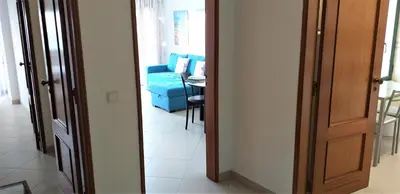 a hallway with a blue couch in a room at Avenida Mar- Vista Mar, Wifi, 150mt Praia in Quarteira