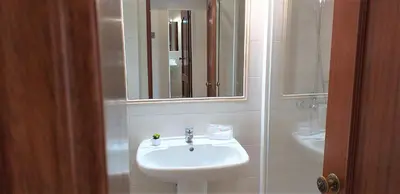 a bathroom with a sink and a mirror at Avenida Mar- Vista Mar, Wifi, 150mt Praia in Quarteira