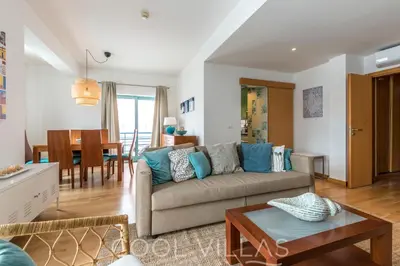 a living room with a couch and a table at Marina Water View - 6 people, bars & restaurants in Albufeira